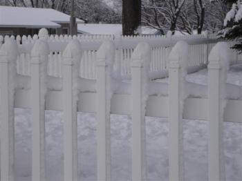 Snow on gate.